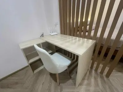 a wooden desk with a white chair next to a staircase at Dime Rama III in Bangkok
