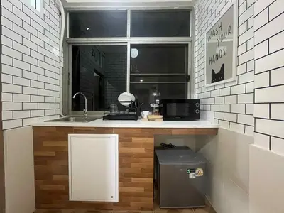 a small kitchen with a sink and a window at Dime Rama III in Bangkok