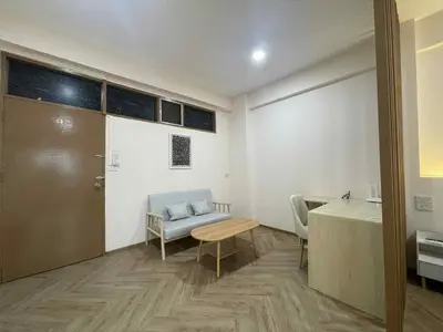 a room with a table and a chair and a desk at Dime Rama III in Bangkok