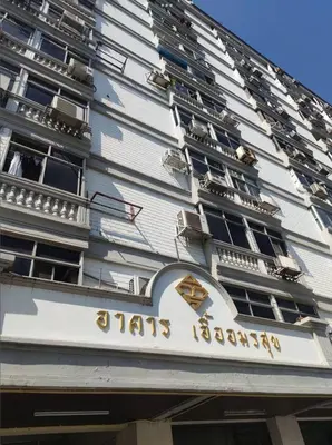 a building with a sign on the side of it at Dime Rama III in Bangkok