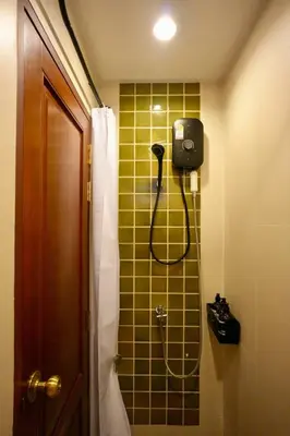 a bathroom with a shower with a phone on the wall at Nivas Wanit 2BR 1SFB Yaowarat MRT EntireHome 80SQM in Bangkok