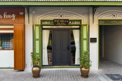 a front door of a building with two vases at Nivas Wanit 3BR 1SFB Yaowarat MRT EntireHome 85SQM in Bangkok