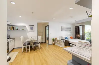 a living room with a bed and a dining room at Cozy 2BR Apt in Central Bangkok 5 mins BTS 110 SQM by MattCo in Bangkok