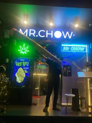 a man standing in front of a mr show sign at Mrchow Nana in Bang Kapi
