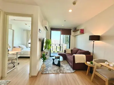 a living room with a couch and a table at Cosy & Bright 1 bedroom in Bangkok