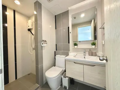 a bathroom with a toilet and a sink at Cosy & Bright 1 bedroom in Bangkok