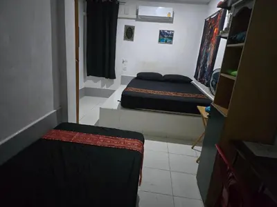 a small room with two beds in it at Jatujak Bangkok guesthouse R8 in Sathani Bang Su