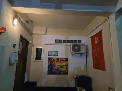 a hallway with a painting on the wall of a room at Jatujak Bangkok guesthouse R8 in Sathani Bang Su