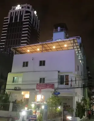 a building with lights on top of it at night at Jatujak Bangkok guesthouse R8 in Sathani Bang Su