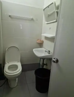 a small bathroom with a toilet and a sink at Jatujak Bangkok guesthouse R8 in Sathani Bang Su