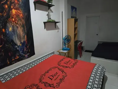 a bedroom with a bed with a red blanket at Jatujak Bangkok guesthouse R8 in Sathani Bang Su
