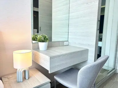 a desk in a room with a chair and a lamp at Luxury & Bright 1 Bedroom - Asoke in Bangkok
