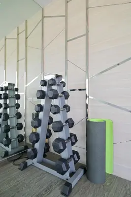 a gym with a bunch of treadmills in a room at Luxury & Bright 1 Bedroom - Asoke in Bangkok
