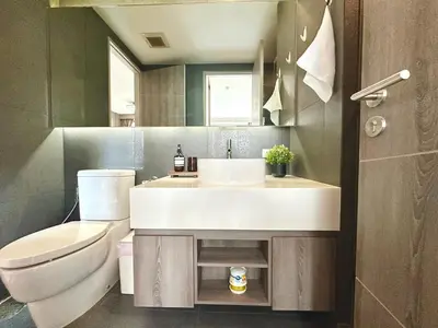 a bathroom with a sink and a toilet at Bright & Spacious 1 BR - ASOKE in Bangkok