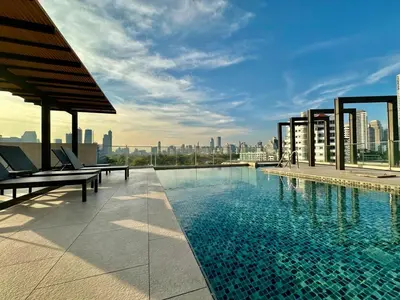 a swimming pool on the roof of a building at Bright & Spacious 1 BR - ASOKE in Bangkok