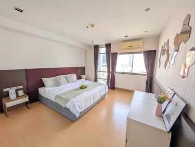 a bedroom with a large bed and a desk in it at High Floor Great View 2BR 2BA 3 mins to Nana BTS in Bangkok