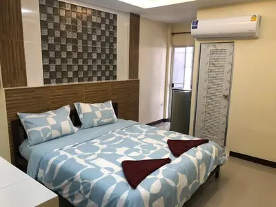a bedroom with a bed with blue and white sheets at 731 Hostel Victory Monument in Sathani Sam Sen