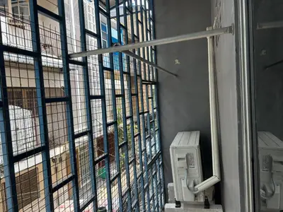 a window with a view of a building at 731 Hostel Victory Monument in Sathani Sam Sen