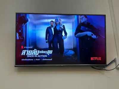 a flat screen tv with a movie on it at 731 Hostel Victory Monument in Sathani Sam Sen