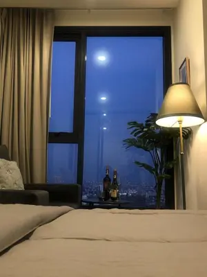 a bedroom with a large window with a city view at Luxury condo in Bangkok,NearBTSMochit,MRTChatuchak in Bangkok