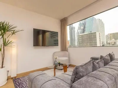 a living room with a couch and a large window at 2 Bedrooms for 3 guest comfy home at heart of Silom - 7A in Bangkok