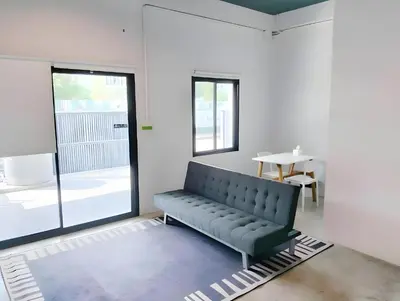 a black bench in a room with a table at XX Yellow Place Sukhumvit Soi 2 - BTS Nana in Bangkok