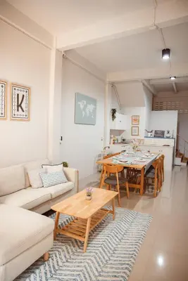 a living room with a couch and a table at Spacious Relaxing Townhouse with Rooftop in Ekamai in Bangkok