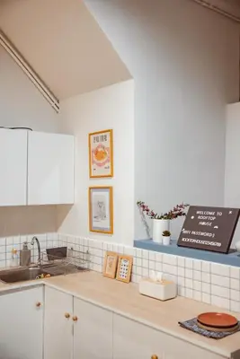 a kitchen with white cabinets and a counter top at Spacious Relaxing Townhouse with Rooftop in Ekamai in Bangkok