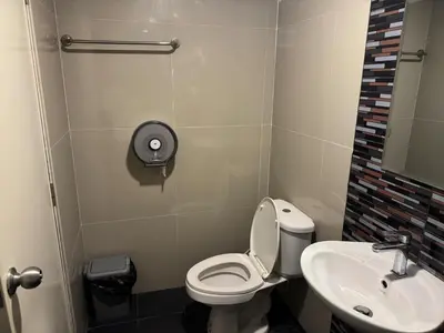 a small bathroom with a toilet and a sink at Natthapimon in Bangkok Yai