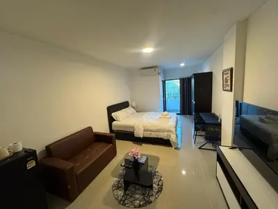 a small living room with a bed and a couch at Natthapimon in Bangkok Yai