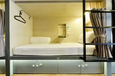a room with a bed on a shelf at The Cube Hostel Silom in Bangkok