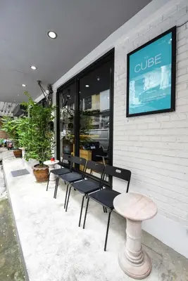 a group of benches sitting outside of a store at The Cube Hostel Silom in Bangkok