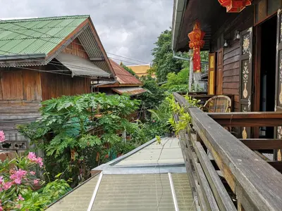 a stairway leading up to a house with flowers at Siamotif Boutique Hotel in Bangkok