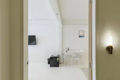 a white room with a sink and a table at 72 House & Cafe in Phra Khanong