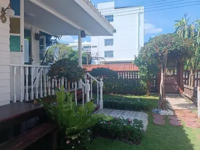 a backyard with a white picket fence and plants at Baan Chay Klong, Canal side Classic Home 2BRs in Ban Bang Toei (1)