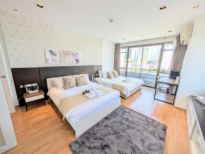 a bedroom with two beds and a large window at Executive 2 Bed Nana BTS 100m Bangkok Skyline in Bangkok
