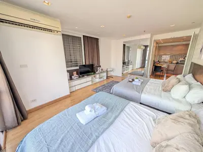 a bedroom with two beds with towels on them at Cozy, Spacious 2-Bedder with City, Park View, Near Nana BTS in Bangkok