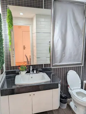 a bathroom with a sink and a toilet at Cozy, Spacious 2-Bedder with City, Park View, Near Nana BTS in Bangkok