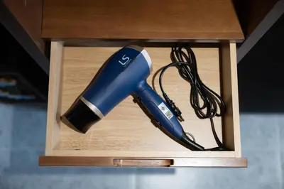 a blue blow dryer in a wooden box at Morya House in Bangkok