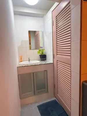 a bathroom with a sink and a mirror at Regalohome Br in Bangkok