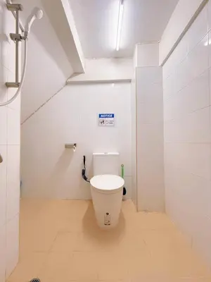 a bathroom with a white toilet in a room at Regalohome Br in Bangkok