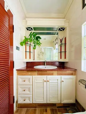 a bathroom with a sink and a mirror at Regalohome Br in Bangkok