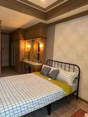 a bedroom with a bed and a desk in it at Regalohome Br in Bangkok
