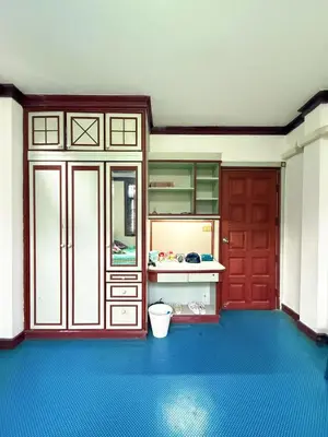 a kitchen with a red door and a blue floor at Regalohome Br in Bangkok