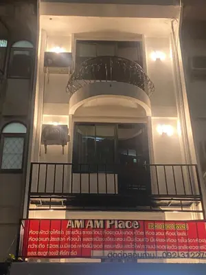 a building with a balcony with a car on it at Am Am Place แอม แอม เพลส in Bangkok