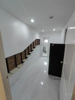 a hallway with a row of stairs in a building at Am Am Place แอม แอม เพลส in Bangkok