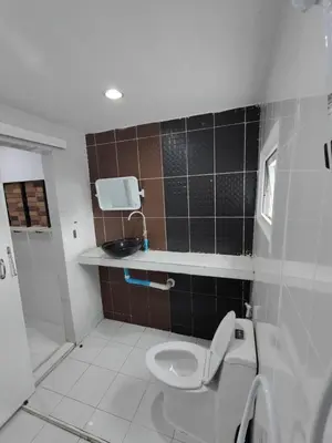 a bathroom with a toilet and a sink at Am Am Place แอม แอม เพลส in Bangkok
