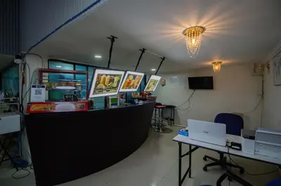 a room with a counter and a desk with a laptop at Skutan-MTB Sutthisan in Bangkok