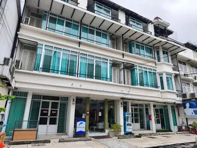 a large building with green and white windows at Skutan-MTB Sutthisan in Bangkok