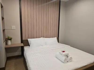 a bedroom with a bed with two towels on it at Victory place 3 in Bangkok